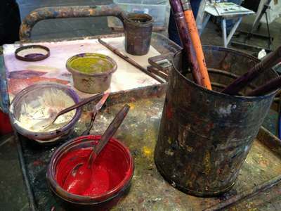 brushes and bowls of paint